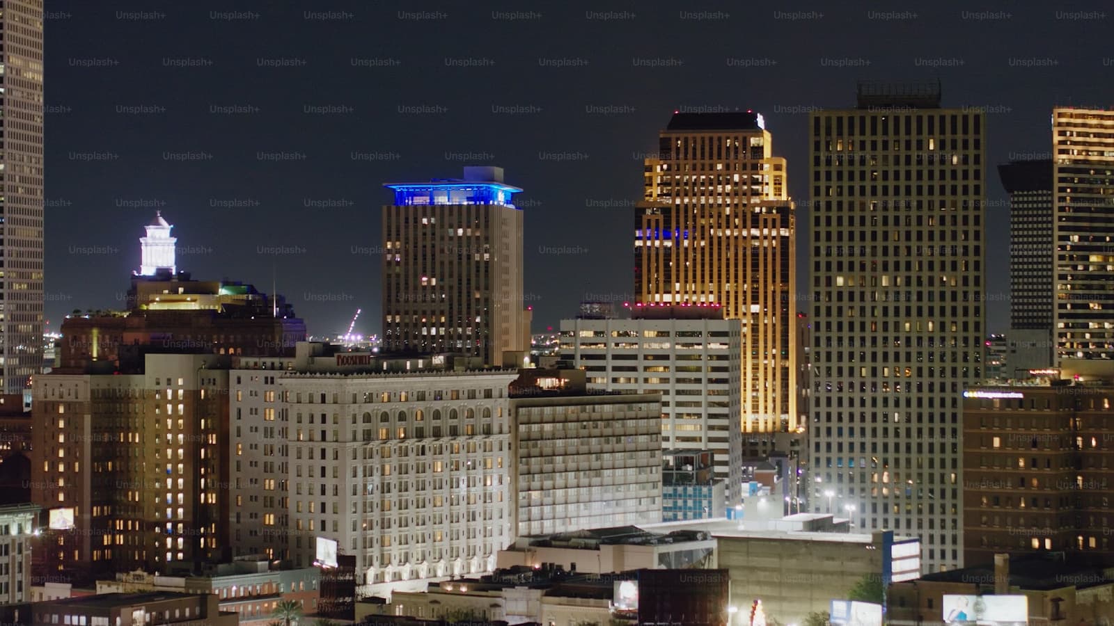 Downtown city skyline at night with illuminated skyscrapers and office buildings