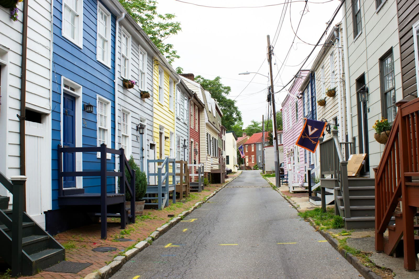 Colorful wooden houses lining a narrow residential street with traditional architecture and front porches