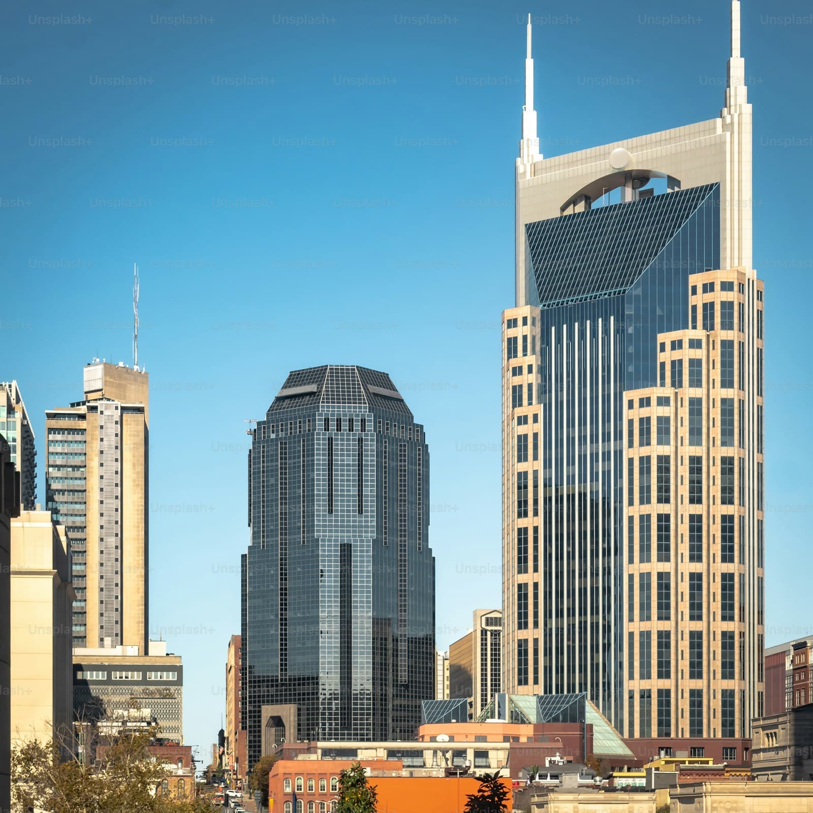Modern city skyline with tall skyscrapers and office buildings against clear blue sky