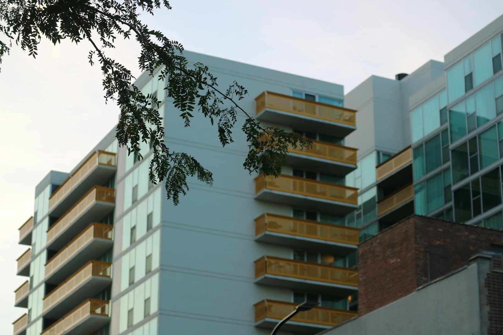 Modern apartment buildings with blue and white facades, balconies, and mixed architectural materials